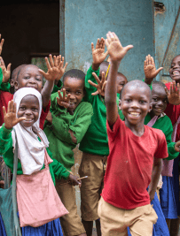 Schoolchildren waving and smiling