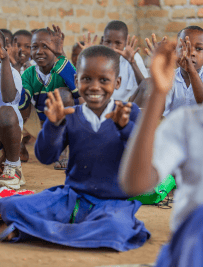 Smiling students participating in classroom activity